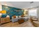 Living room features a comfortable gray sectional couch, wood furniture, a striking fish-themed wall, and bright lighting at 205 71St St # B, Holmes Beach, FL 34217