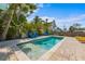 Inviting backyard features a private pool surrounded by lush landscaping and comfortable seating areas at 205 71St St # B, Holmes Beach, FL 34217