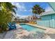 Tranquil backyard features a private pool surrounded by lush greenery and comfortable seating for outdoor relaxation at 205 71St St # B, Holmes Beach, FL 34217