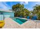 Backyard oasis featuring a refreshing private pool surrounded by comfortable lounge chairs and tropical landscaping at 205 71St St # B, Holmes Beach, FL 34217