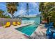 Relaxing backyard featuring a private pool surrounded by comfortable lounge chairs, perfect for outdoor enjoyment at 205 71St St # B, Holmes Beach, FL 34217