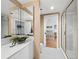 Bathroom features a double vanity, a large mirror, a shower with glass door, and access to the bedroom at 2120 Harbourside Dr # 617, Longboat Key, FL 34228