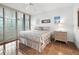 Serene bedroom featuring sliding doors leading to the outside, neutral tones, and tile flooring at 2120 Harbourside Dr # 617, Longboat Key, FL 34228
