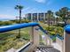 Coastal condominium building with lush grounds, water views, and blue railing accents at 2120 Harbourside Dr # 617, Longboat Key, FL 34228