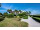 Scenic walking path with lush landscaping leading to condos and waterfront views at 2120 Harbourside Dr # 617, Longboat Key, FL 34228