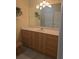 Bathroom with a vanity sink, wooden cabinets, ample counter space and updated fixtures at 24028 Park Place S Dr # 32, Punta Gorda, FL 33980