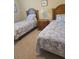 Bedroom with two twin beds, carpet flooring, and matching nightstand at 24028 Park Place S Dr # 32, Punta Gorda, FL 33980