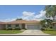 Charming single Gathering home with a well-manicured front lawn, a neutral color palette and screen enclosed garage at 24028 Park Place S Dr # 32, Punta Gorda, FL 33980
