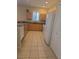 The kitchen features tile flooring, wooden cabinets, granite countertops and white appliances at 24028 Park Place S Dr # 32, Punta Gorda, FL 33980