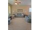 Comfortable living room with carpet flooring, large windows, and comfortable seating at 24028 Park Place S Dr # 32, Punta Gorda, FL 33980