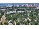 Aerial view of a residential neighborhood showcasing a two-story home surrounded by mature trees and tropical greenery at 2485 S Milmar Dr, Sarasota, FL 34237