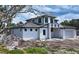 Exterior of a modern two-story home with a stone facade and black trim windows situated on a lot under construction at 2485 S Milmar Dr, Sarasota, FL 34237