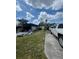 Backyard featuring an open carport, truck and additional storage sheds at 2494 S Milmar Dr, Sarasota, FL 34237
