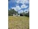 Rear exterior view with a covered area, landscaping and ample yard space at 2494 S Milmar Dr, Sarasota, FL 34237