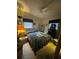 Cozy bedroom featuring a ceiling fan, window, and furnishings at 2494 S Milmar Dr, Sarasota, FL 34237
