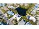 An aerial view of a neighborhood with the house having a pool and solar panels at 306 68Th St, Holmes Beach, FL 34217