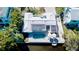 Aerial view of a waterfront home with a private pool, dock, and solar panels at 306 68Th St, Holmes Beach, FL 34217