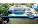 Aerial view of private pool, brick patio and waterfront access with solar panels on home at 306 68Th St, Holmes Beach, FL 34217