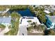 Stunning aerial view of waterfront home with solar panels, lush landscaping, and serene water views at 306 68Th St, Holmes Beach, FL 34217