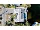 Aerial view showcases waterfront home featuring a pool, solar panels, and tropical landscaping at 306 68Th St, Holmes Beach, FL 34217