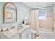 Bathroom features a vanity with a sink, decorative mirror, toilet, and shower/tub combo at 306 68Th St, Holmes Beach, FL 34217