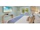 Bedroom with a king size bed, tiled floors, console table with tv, and window views at 306 68Th St, Holmes Beach, FL 34217