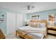 Comfortable bedroom with ample natural light, a ceiling fan, and neutral tones, creating a relaxing and inviting space at 306 68Th St, Holmes Beach, FL 34217