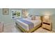 Bedroom with a king size bed, tiled floors, two side tables and a window with natural light at 306 68Th St, Holmes Beach, FL 34217