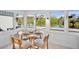 Charming dining area with picturesque views of the lush greenery and serene pond, surrounded by bright windows at 306 68Th St, Holmes Beach, FL 34217