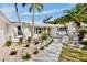 Charming single-story home featuring tropical landscaping, palm trees, and a welcoming entrance at 306 68Th St, Holmes Beach, FL 34217