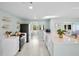 Bright kitchen with white cabinets, stainless steel appliances, and an open layout to the living areas at 306 68Th St, Holmes Beach, FL 34217