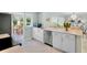 Modern kitchen with stainless steel appliances, white cabinetry, and views of the dining area at 306 68Th St, Holmes Beach, FL 34217