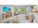 Bright main bedroom featuring comfortable decor, scenic views, and a calming atmosphere in a stylish home at 306 68Th St, Holmes Beach, FL 34217