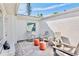 Cozy patio with stone floors, stylish orange side tables and comfortable gray chairs at 306 68Th St, Holmes Beach, FL 34217