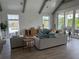 Spacious living room with wood floors, white walls, and modern furniture at 307 Magnolia Ave, Anna Maria, FL 34216