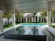 Inviting outdoor space featuring a modern pool, spa, and covered patio with beautiful pavers at 307 Magnolia Ave, Anna Maria, FL 34216