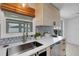 Kitchen featuring stainless steel sink, light wood cabinets, and stylish countertops with a window at 3219 Florida Blvd, Bradenton, FL 34207