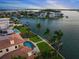 Stunning aerial view showcasing a waterfront property with a pool, dock, and lush landscaping in a desirable location at 3576 San Remo Ter, Sarasota, FL 34239