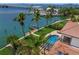 Waterfront home featuring a beautiful pool, lush landscaping, and private boat dock with open bay access at 3576 San Remo Ter, Sarasota, FL 34239