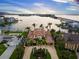 Magnificent waterfront estate with lush landscaping, circular driveway, and stunning water views at 3576 San Remo Ter, Sarasota, FL 34239