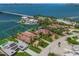 Waterfront property showcasing a beautiful home with a pool, lush landscaping, and a dock on the water at 3576 San Remo Ter, Sarasota, FL 34239