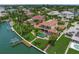 Waterfront property with a private boat dock, lush landscaping, large pool, and spacious balconies overlooking the bay at 3576 San Remo Ter, Sarasota, FL 34239