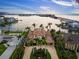 Waterfront property boasts a private dock and lush tropical landscaping, perfect for boating and waterfront enjoyment at 3576 San Remo Ter, Sarasota, FL 34239