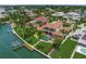 Stunning waterfront home featuring a private pool, lush landscaping, and a private dock with boat lift at 3576 San Remo Ter, Sarasota, FL 34239