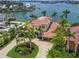 Expansive aerial view reveals a luxurious waterfront estate with lush landscaping and a circular driveway at 3576 San Remo Ter, Sarasota, FL 34239