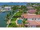 A waterfront property with a private boat dock and large pool, surrounded by lush landscaping with bay access at 3576 San Remo Ter, Sarasota, FL 34239