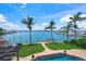 Aerial view of the landscaped backyard, pool, boat dock, and waterfront at 3576 San Remo Ter, Sarasota, FL 34239