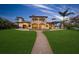 Expansive backyard featuring lush green lawn, a charming pathway, and an elegant home exterior for ultimate relaxation at 3576 San Remo Ter, Sarasota, FL 34239