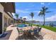 Outdoor dining area featuring a spacious patio, pool, and scenic waterfront views, a perfect setting for alfresco meals at 3576 San Remo Ter, Sarasota, FL 34239