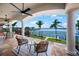 Stunning waterfront balcony featuring seating and panoramic water views with lush palms, ideal for serene outdoor living at 3576 San Remo Ter, Sarasota, FL 34239